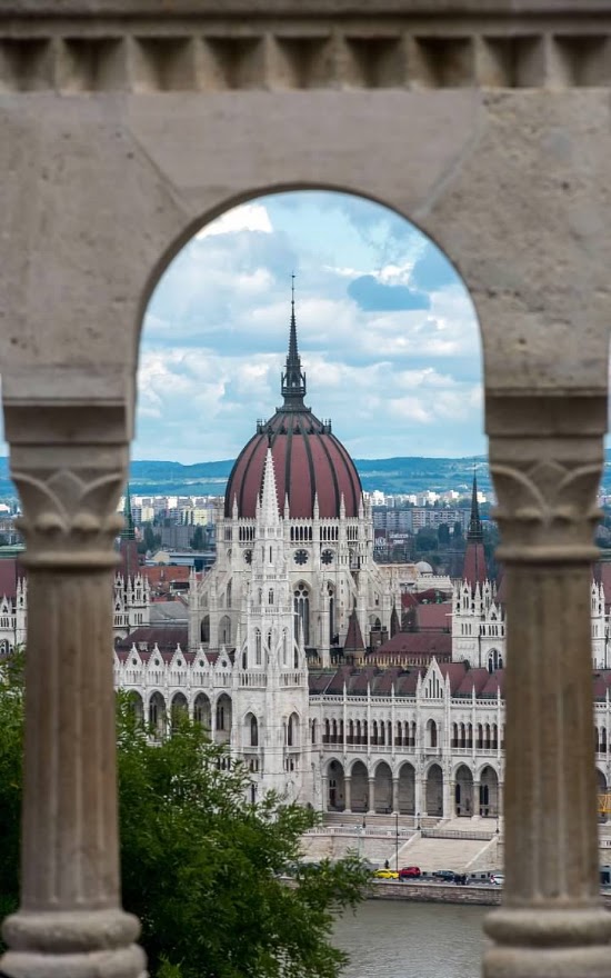 Photo of a European domed church framed by an arch