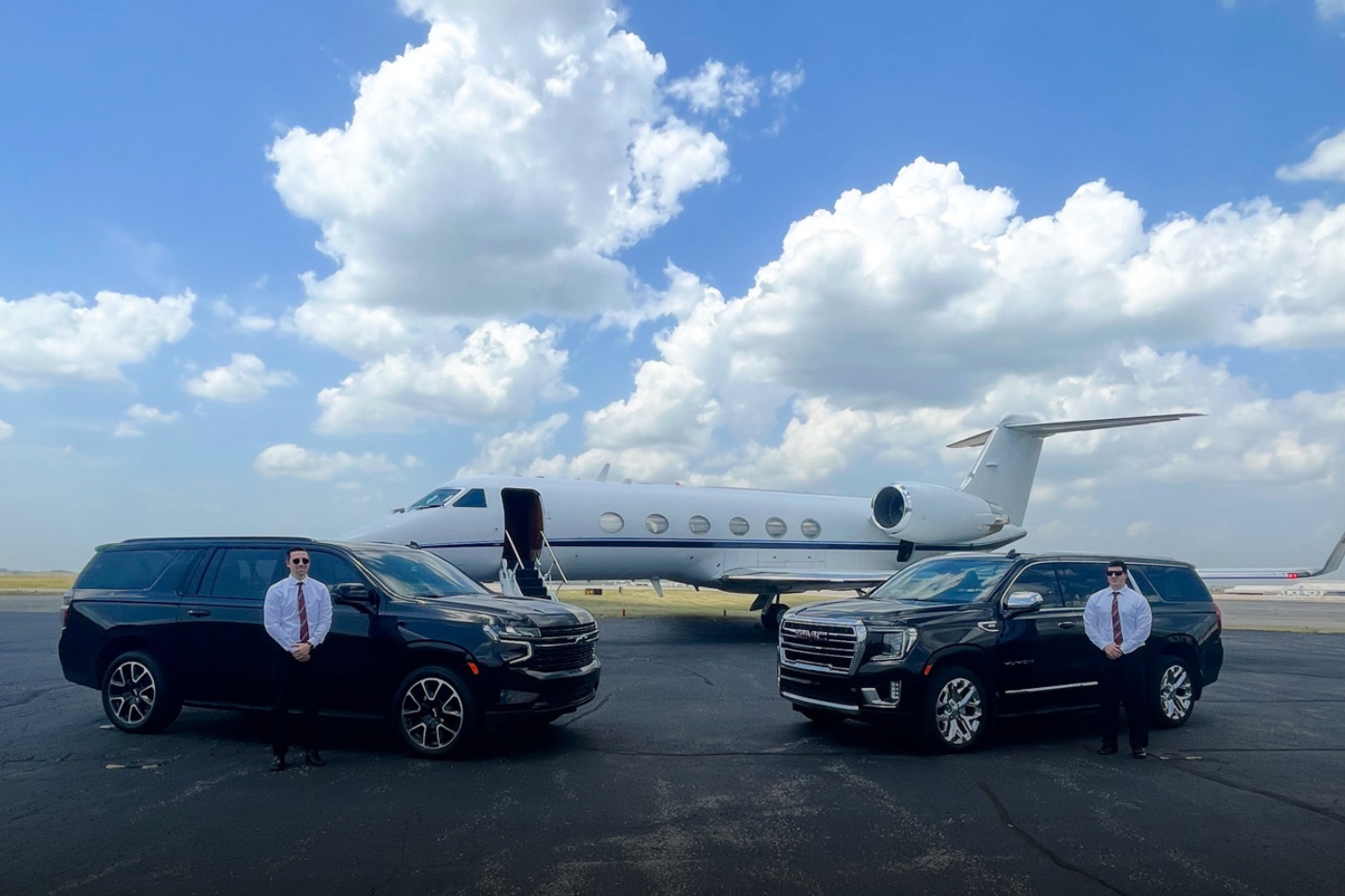 Select T-Rides Pics - 3 Photo of a private jet and two black SUVs waiting to take their passengers on a ride.
