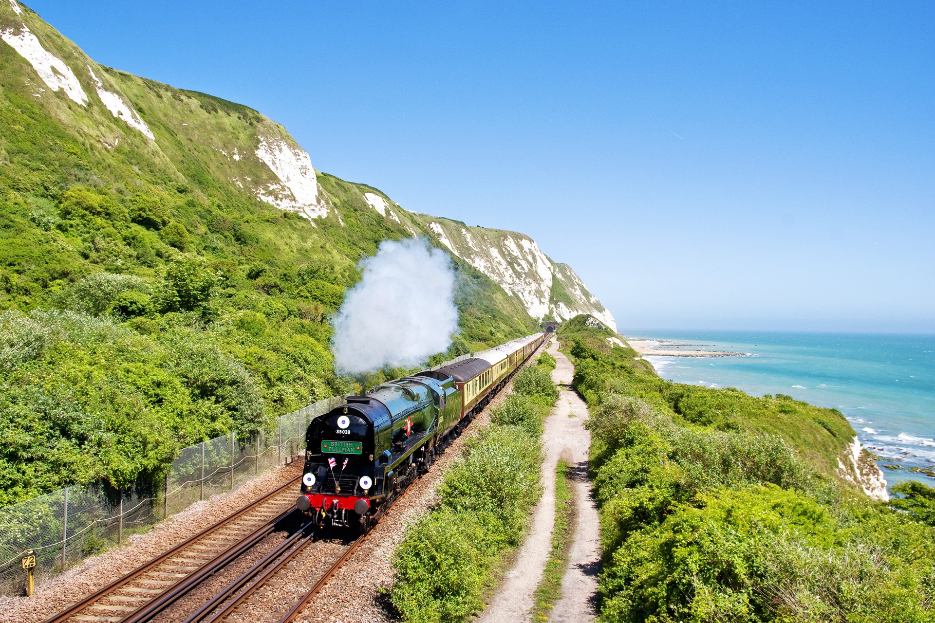 PUL-EXT-16 External images of British Pullman hauled by Clanline steam engine along the Kent coast.