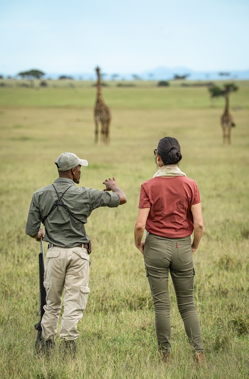 Guest with safari guide looking at the animals