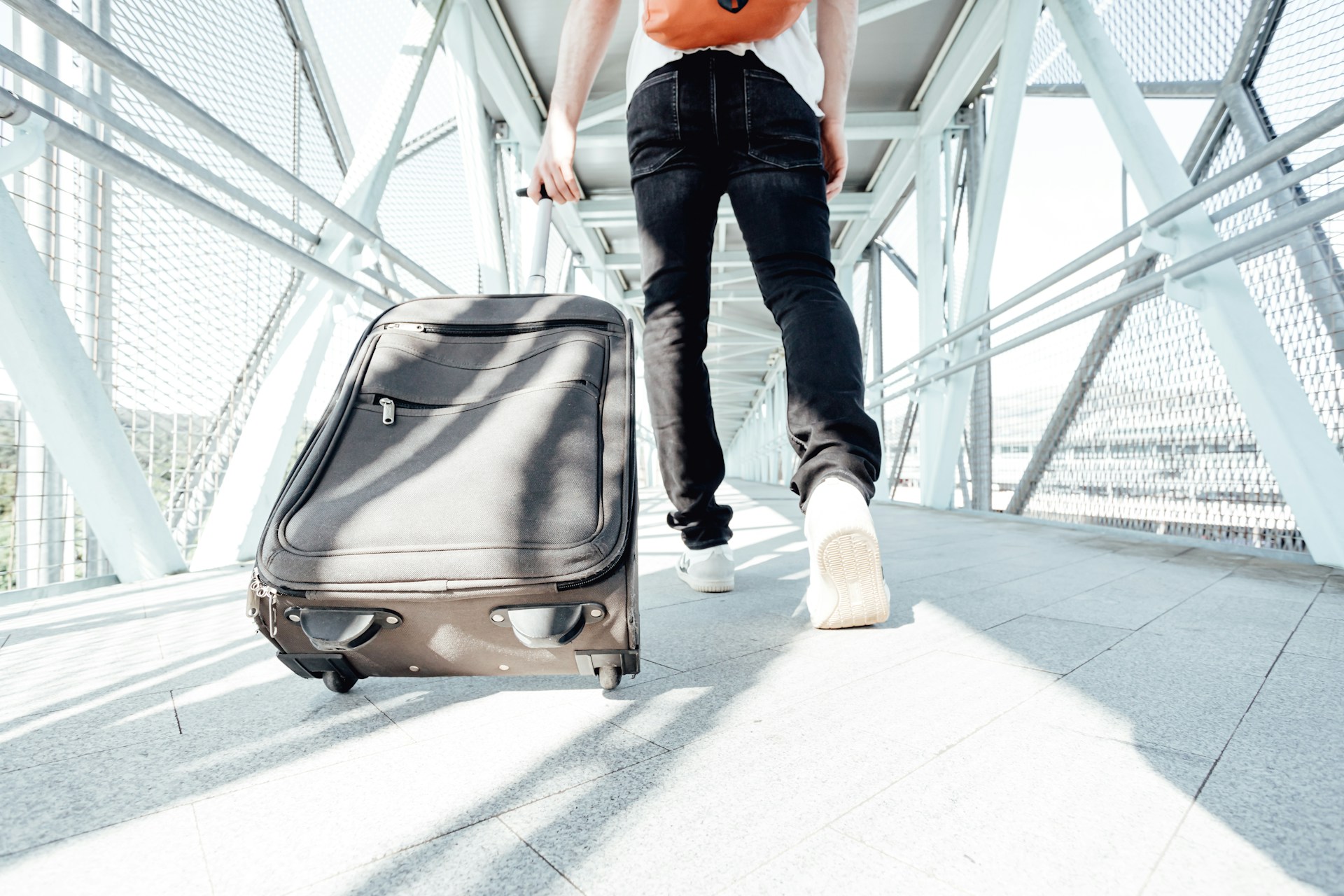 Photo of a person pulling their luggage as shot from low and behind