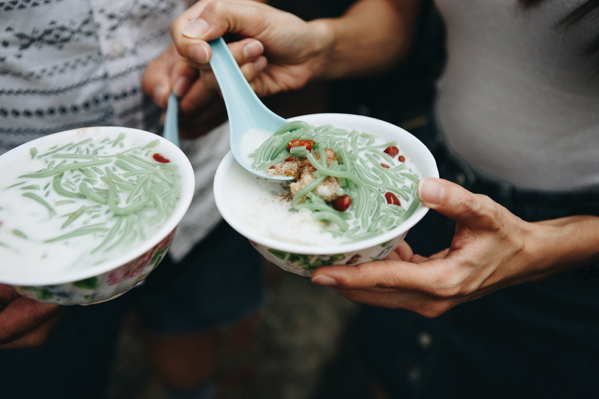 curated-lifestyle-iDP2-7yndSQ-unsplash Photo of two bowls of Asian food being shared by friends.