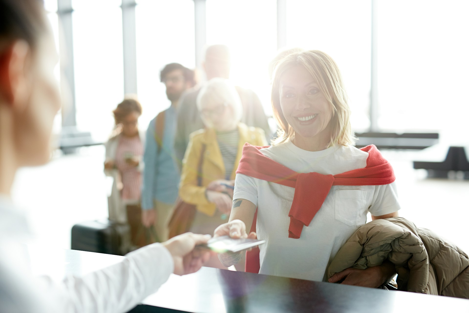Photo of a person approaching the ticket desk in an airport