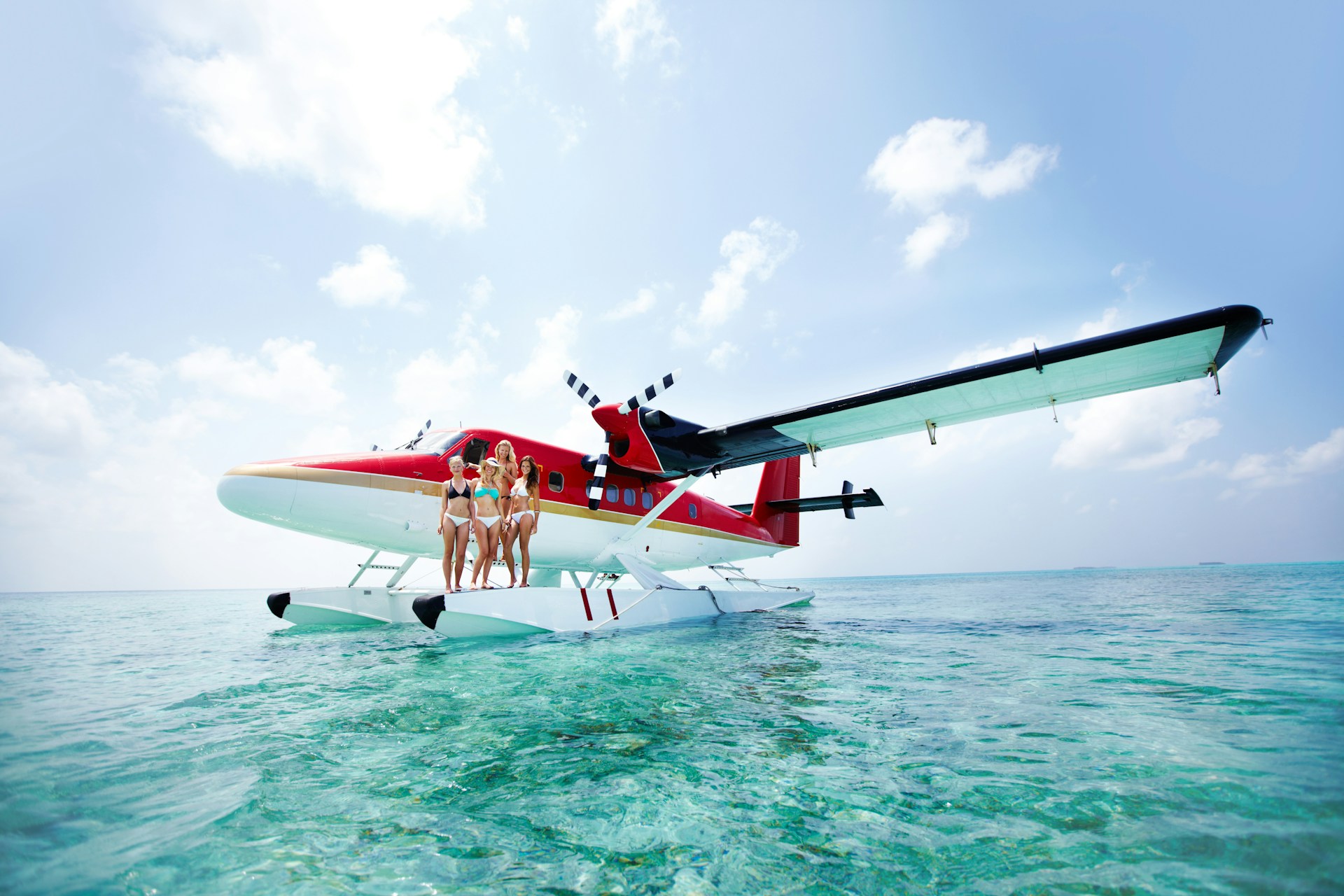 Photo of a seaplane landed with a group of people ready to jump into the water